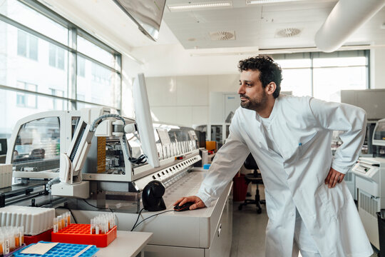 Scientist analyzing data on computer in modern hospital laboratory