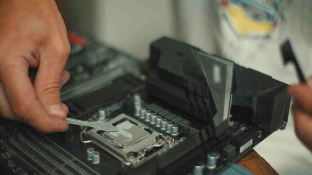 Building a PC with hands-on steps for installing CPU and motherboard components in a home setup