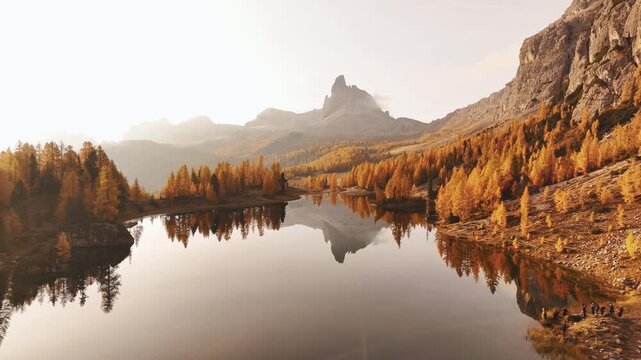 Reflections is in water. Lake Federa near the Croda da Lago mountain at autumn time, majestic landscape, raw nature.