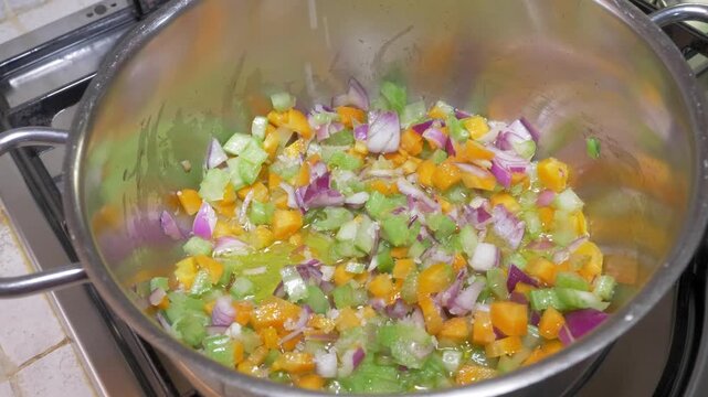 Steam rises gently from a pot of sizzling soffritto as celery, carrots and onion cook down together, filling the home kitchen with the warm and inviting scent of Italian cooking.