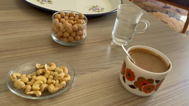Sparkling water and delicious nuts alongside Turkish coffee.