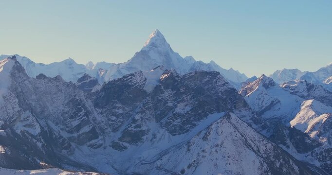Kala Patthar, Everest Nepal, drone aerial shot over rugged alpine terrain revealing the iconic Ama Dablam mountain peak rising above the Khumbu valley along the Everest Base Camp trekking route.