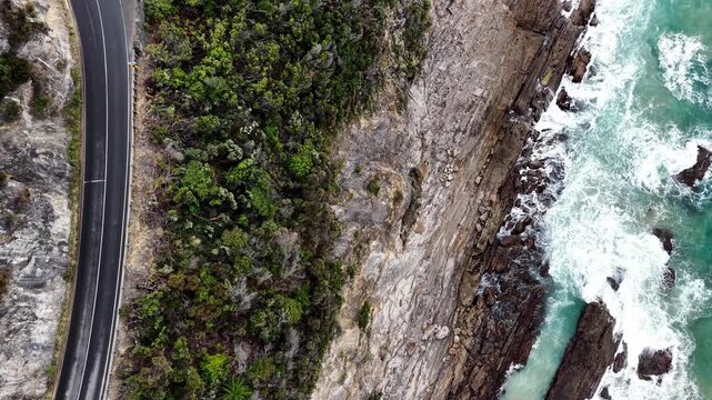Cliffs and sea surface aerial lift along Great Ocean road lookouts in Australia.