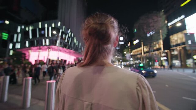 Close up portrait of a woman watching the glowing skyline of Singapore City featuring illuminated urban streets contemporary architecture and tourism in Asia
