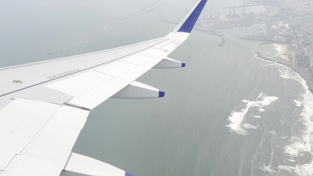 Airplane wing flying above a bright cloud layer under a dramatic blue sky, scenic aerial view from passenger window showing commercial aviation, altitude travel, freedom, journey and serene atmosphere