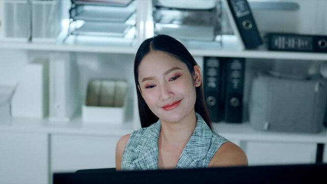 Asian businesswoman taking a short break while working in a modern office, promoting workplace wellness, stress relief, productivity, and a healthy work-life balance in a professional environment.