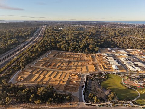 Golden Hour Aerial View of New Residential Housing Development Beside Native Bushland in Western Australia