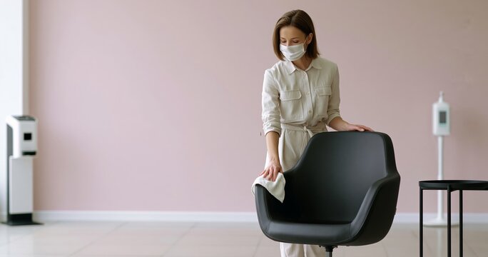 Woman cleaning chair in modern