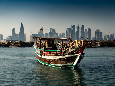 Doha sea cruise scene with traditional Dhow and city skyline in the background