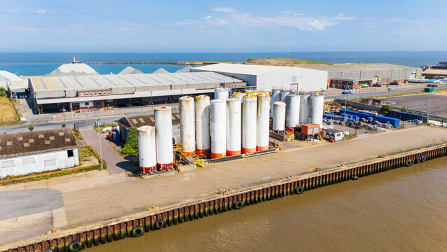 Aerial view of a group of chemical storage tanks on the River Yare in Great Yarmouth, North Norfolk, UK