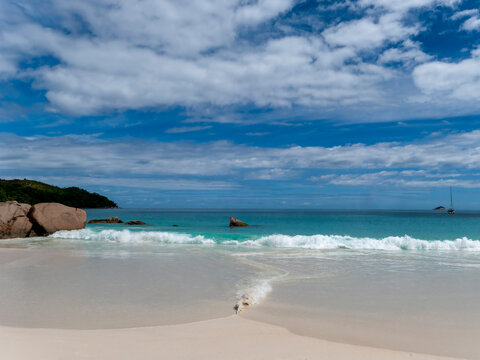 A beautiful beach with the typical rock formations of the Seychelles off the coast of Praslin Island.