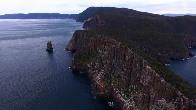 Towering sea stacks and cliffs beside open ocean