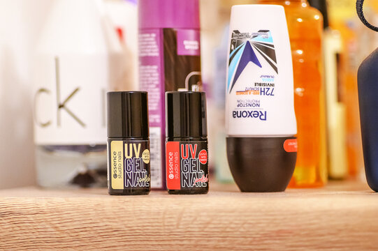 Iserlohn, Germany - July 04, 2026: Essence Studio Nails UV gel nail polish and Rexona deodorant on a wooden surface