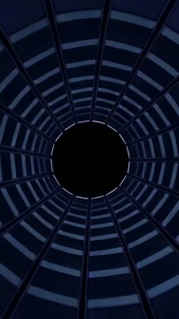 Vertical video: Tilting camera showing circular shaft in atrium shifting grid, revealing rod