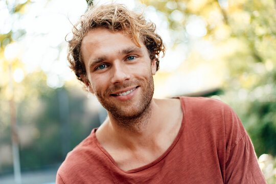 Smiling blond young man outdoors