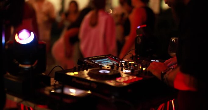 DJ playing music during summer party outdoor at disco club holiday resort - Entertainment and vacation night life concept - UGC content