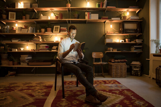 Man reading a book at home