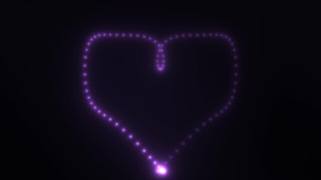 Shape of a glowing heart drawn with light on a dark background