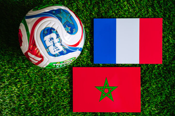 Fototapeta premium FIFA World Cup 2026 quarterfinal: France vs Morocco, national flags before international football match. Editorial football scene on green grass pitch inside stadium light, Foxborough, United States.