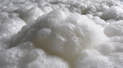 Obraz premium Close-Up View of Soft White Foam Bubbles on a Surface in Bright Light Highlighting Texture and Patterns