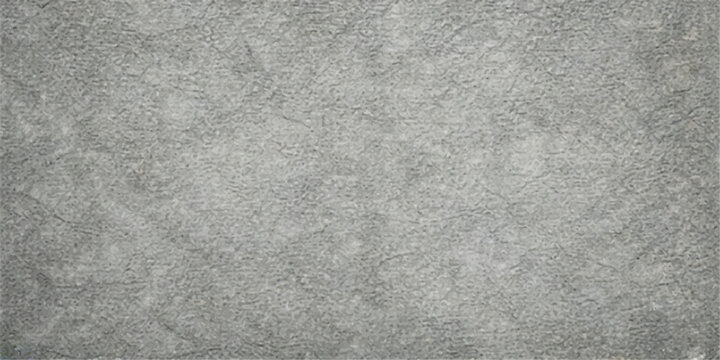 A textured close-up reveals the intricate detail of a rough gray stone surface, showcasing subtle variations in color and a gritty, weathered appearance.