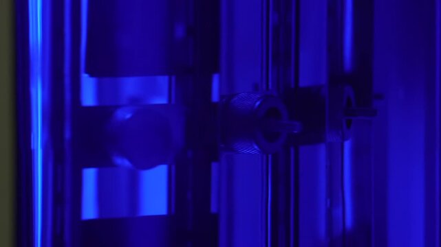 Close-up of test samples inside a xenon weathering chamber during accelerated material aging and durability testing in an industrial laboratory.