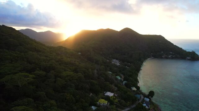 Praslin island at sunset in the Seychelles. Aerial ascent