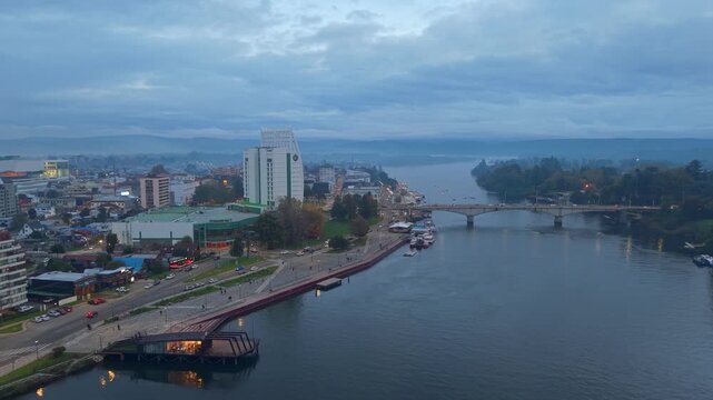 Panoramic aerial view of Valdivia, Chile, during the blue hour, Calle Calle River, and the bridge to Teja Island