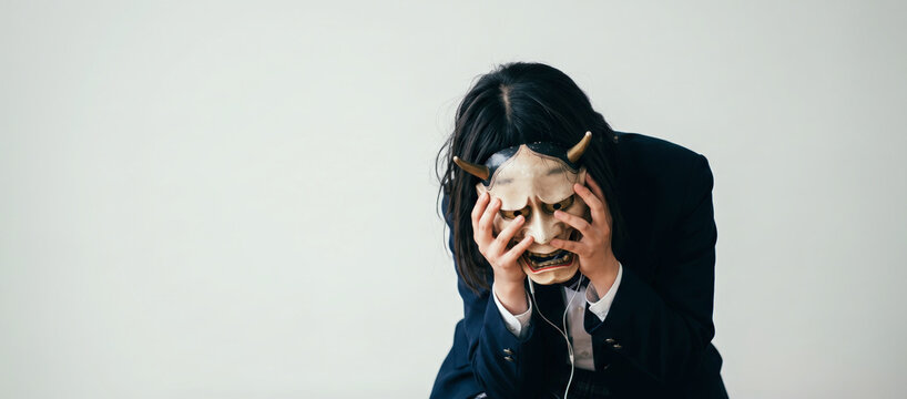 Stressed Student Holding Hannya Mask, Hidden Emotions and Mental Health Concept with Copy Space