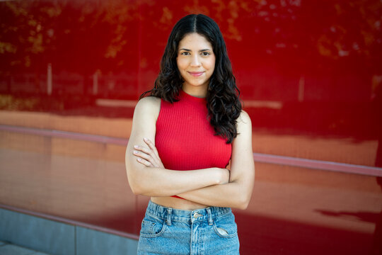 Young woman showing confidence standing with crossed arms