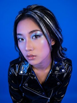 Stunning Portrait of a Stylish Young Woman with Avant-Garde Metallic Makeup and Black Leather