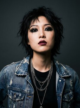 Portrait of a Young Asian Woman with Shaggy Black Hair and Alternative Grunge Fashion Style
