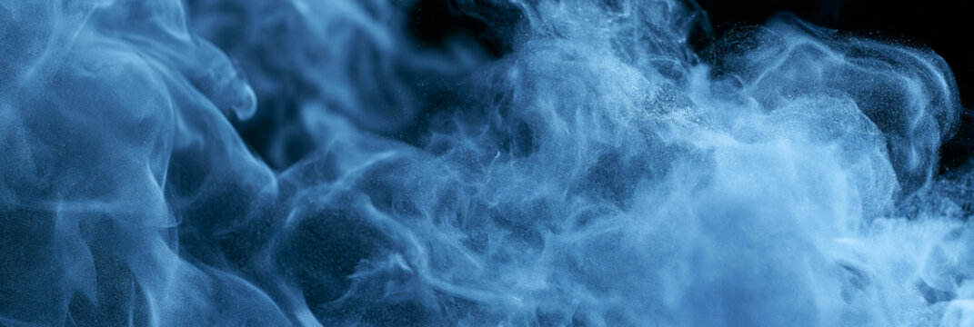 Abstract blue smoke patterns swirling in a dark background.