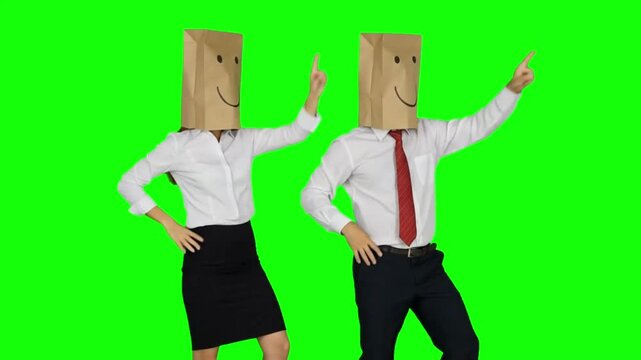 Anonymous business team wearing paper bags with drawn smiley faces dancing and celebrating victory together on green screen.