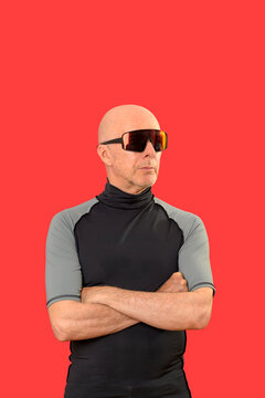 sporty bald man standing with arms folded