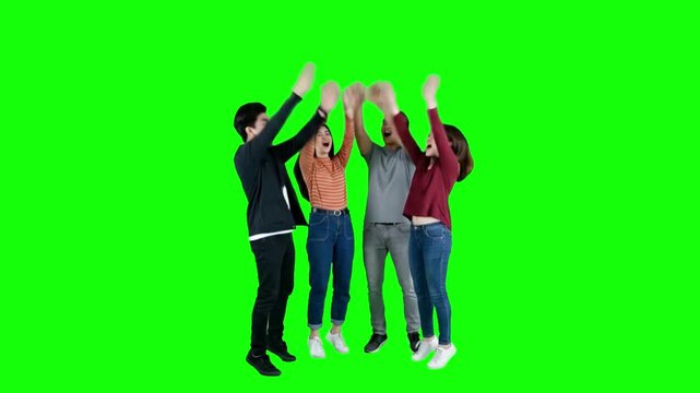 Diverse Group of Young Friends Joining Hands and Cheering on Green Screen