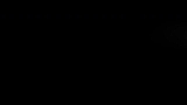 Animation of a stylized comet moving slowly from left to right, leaving a trail of smoke  on a black background.