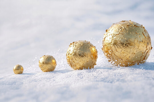 Concept of compound interest and wealth growth represented by golden snowballs increasing in size on white snow, snowball effect