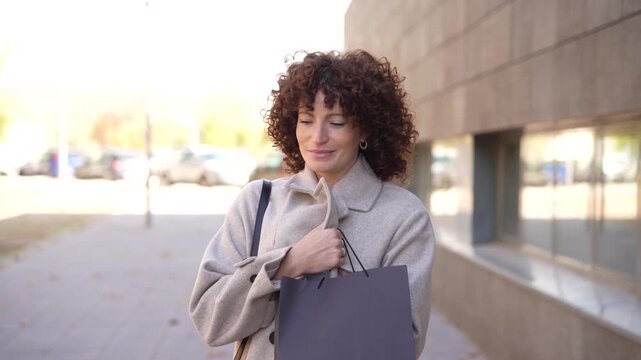 A Confident Woman Strolling Outdoors, Wearing a Stylish Coat and Radiating Elegance and Charm