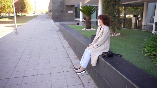 Casual Outdoor Fashion A Woman Taking Time to Relax in an Urban Setting Surrounded by Nature