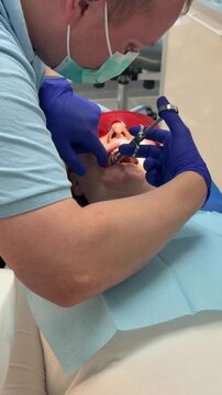 woman in dentistry tooth filling injection anesthesia. modern dental treatment with local anesthesia rubber dam filling procedure suction and bite check during professional tooth restoration