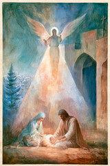Fototapeta premium Mary and Joseph are together with the baby Jesus in a stable. An angel hovers above them, shining a bright light over the scene