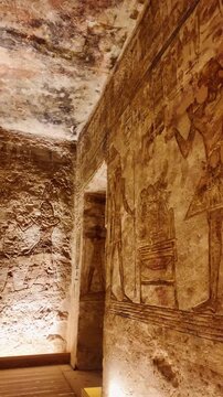 Interior chamber of the ancient abu simbel temple in egypt, showcasing intricate hieroglyphic carvings and bas reliefs on stone walls