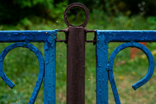 old rusty metal fence on blue sky