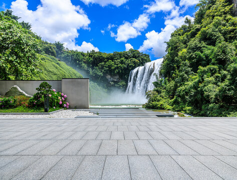 Empty platform overlooking the majestic Huangguoshu waterfall and lush forest in Anshun, Guizhou, China