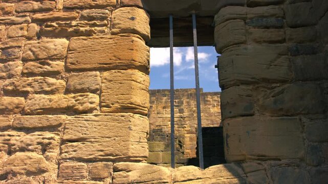 Prison bars on a stone wall