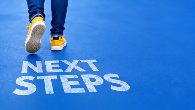 Next Steps concept with person walking on blue background
