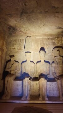 Ancient egyptian statues of ramses ii and gods inside the rock hewn sanctuary of the great temple of abu simbel, a nubian monument