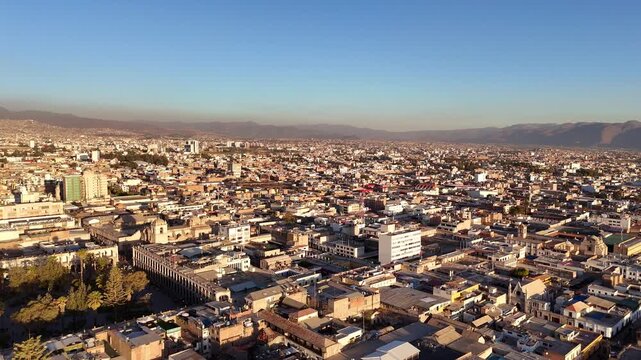 the expansive urban landscape of Arequipa, Peru, showcasing dense city rooftops and distant mountain ridges