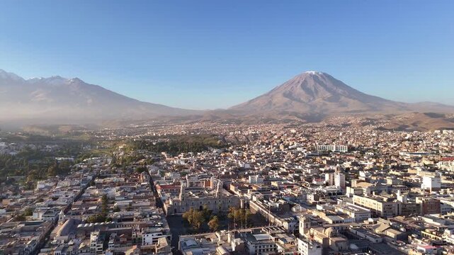 An aerial panning shot rotates to the left over Arequipa, Peru, showcasing the cityscape transitioning from El Misti to Chachani volcano